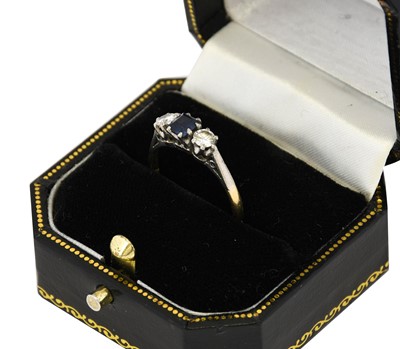Lot 1064 - A sapphire and diamond three stone ring, the...