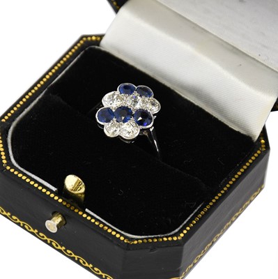 Lot 1087 - A synthetic sapphire and diamond cluster ring,...