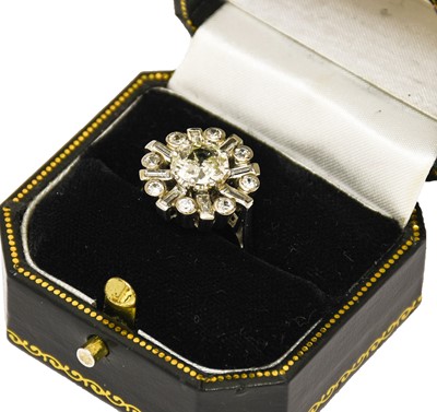 Lot 1101 - A diamond cluster ring, the central round...