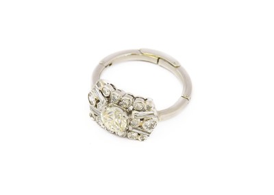 Lot 1100 - A diamond cluster ring, the central round...