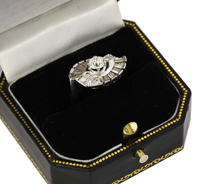 Lot 1059 - A diamond cluster ring, the central round...