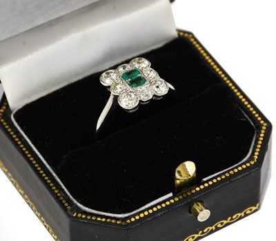 Lot 1076 - An emerald and diamond cluster ring, two...