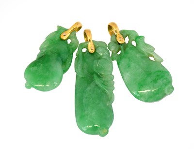 Lot 1085 - Three jade pendants, each pierced pendant drop...