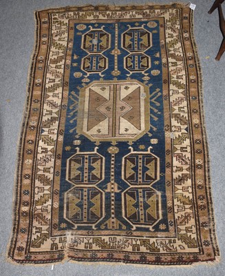 Lot 1218 - A Kazak rug, the indigo field with three...