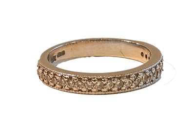 Lot 1070 - A platinum diamond half hoop ring, the round...