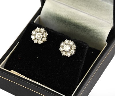 Lot 1107 - A pair of diamond cluster earrings, the...