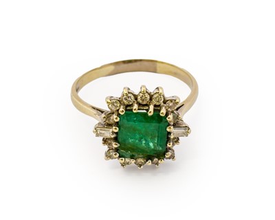 Lot 1111 - An emerald and diamond cluster ring, the...