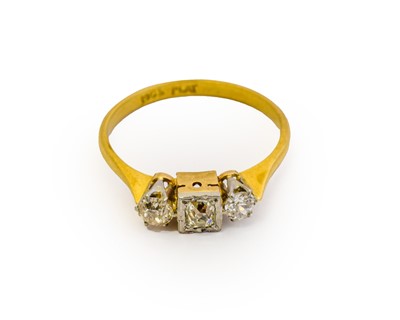 Lot 1043 - A diamond three stone ring, the cushion cut...