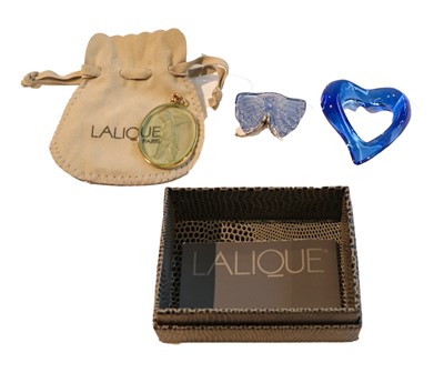 Lot 1075 - A Lalique pendant, the oval clear green glass...