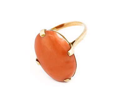 Lot 1068 - A coral ring, the oval cabochon coral in a...