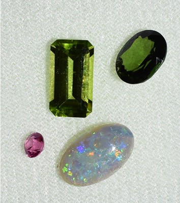 Lot 141 - A loose oval cabochon opal, weighing 1.35...