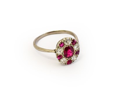 Lot 1077 - A synthetic ruby and diamond cluster ring, the...