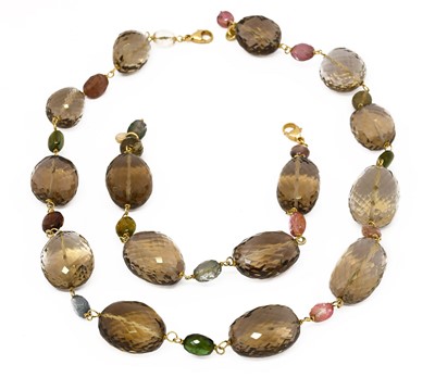 Lot 1037 - An 18 carat gold quartz and multi-gem set bead...