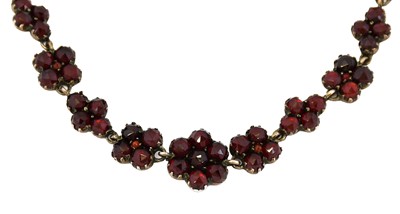 Lot 1053 - A Victorian garnet necklace, formed of...
