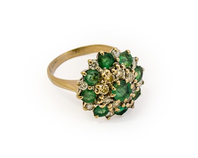 Lot 1042 - An emerald and diamond cluster ring, the...