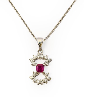 Lot 1084 - A ruby and diamond pendant on chain, the bow...