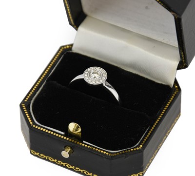 Lot 1058 - An 18 carat white gold diamond ring, the...
