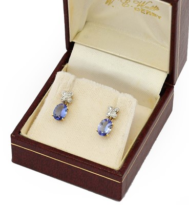 Lot 1081 - A pair of tanzanite and diamond drop earrings,...