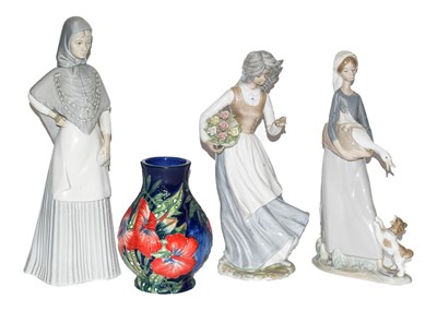 Lot 41 - A Lladro figure, two similar figures, a...