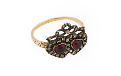 Lot 1113 - A garnet and diamond twinned heart ring, the...