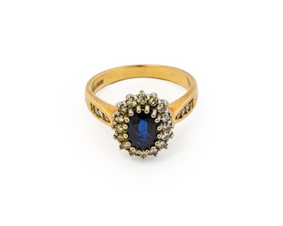 Lot 1002 - A 9 carat gold sapphire and diamond cluster...
