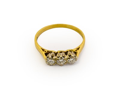 Lot 1089 - An 18 carat gold diamond three stone ring, the...