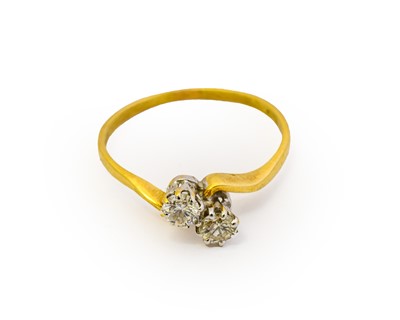 Lot 1106 - An 18 carat gold diamond two stone twist ring,...