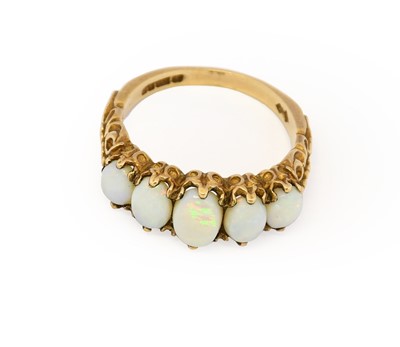 Lot 1030 - A 9 carat gold opal five stone ring, the...