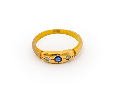 Lot 1099 - A sapphire and diamond three stone ring, a...