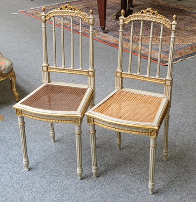 Lot 1122 - A pair of French cream painted parcel-gilt...