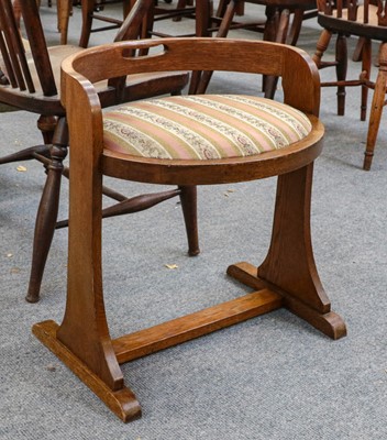 Lot 1345 - An Arts & Crafts oak piano stool, with curved...