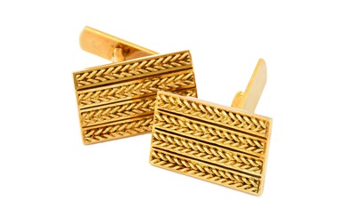 Lot 1033 - A pair of 18 carat gold cufflinks, the yellow...