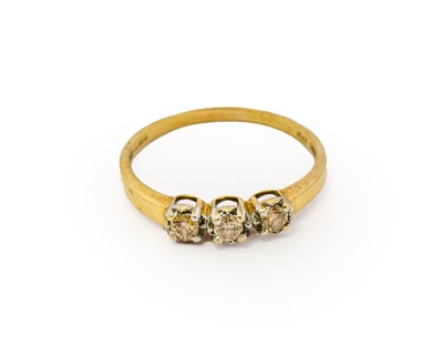 Lot 1120 - A 9 carat gold diamond three stone ring, the...