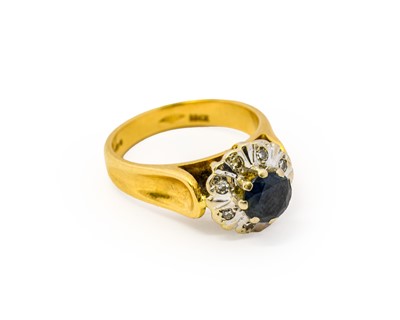 Lot 1124 - An 18 carat gold sapphire and diamond cluster...
