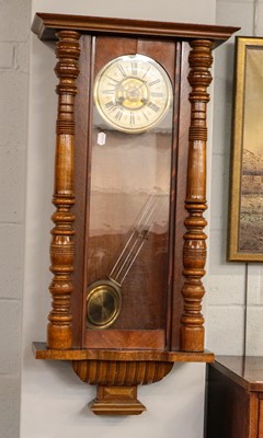 Lot 1421 - A walnut veneered Vienna type striking wall...