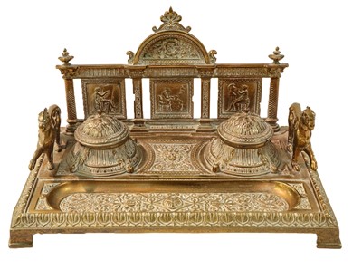 Lot 342 - An Edwardian brass desk stand cast with face...
