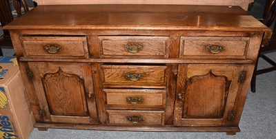 Lot 1261 - A 20th century oak sideboard in the manor of...
