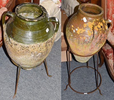 Lot 1242 - Two part-glazed amphoras on metal stands