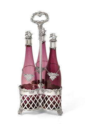 Lot 2265 - A Victorian Silver Plate Three-Bottle Decanter Stand With Three Cranberry Glass Decanters