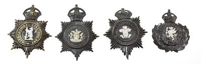 Lot 2052 - Four Blackened Die Stamped Brass Helmet Plates,...
