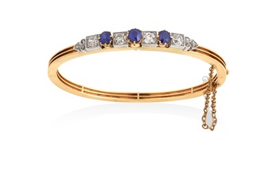 Lot 2015 - A Sapphire and Diamond Bangle three round cut...