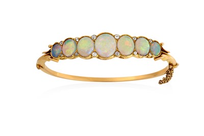 Lot 2055 - An Opal and Diamond Bangle the seven graduated...