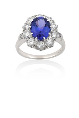 Lot 2018 - A Tanzanite and Diamond Cluster Ring the oval...