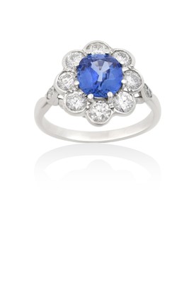 Lot 2017 - A Sapphire and Diamond Cluster Ring the round...