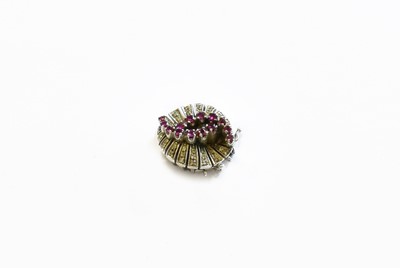 Lot 87 - A Ruby and Diamond Clasp, the swirl motif set...