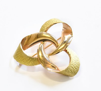 Lot 114 - A Ribbon Motif Brooch, with applied plaque...