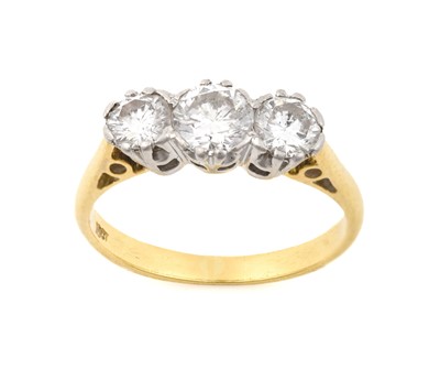 Lot 2077 - A Diamond Three Stone Ring the graduated round...