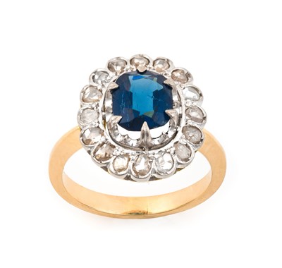 Lot 2074 - A Sapphire and Diamond Cluster Ring the oval...