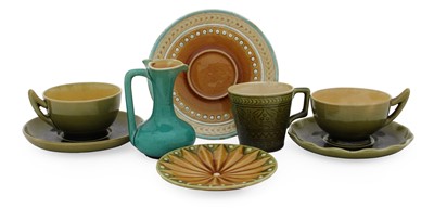 Lot 560 - Two Linthorpe Pottery Cups and Saucers, olive...