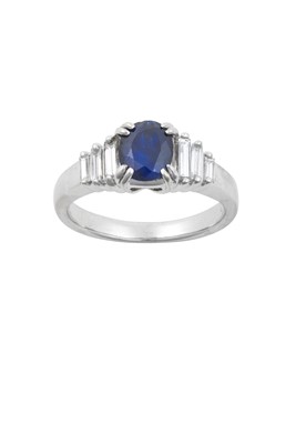 Lot 2225 - A Sapphire and Diamond Ring the oval cut...